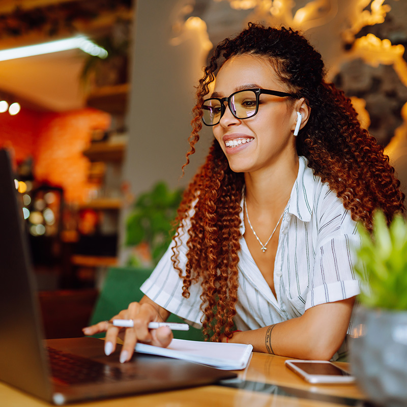 Woman at laptop, training to become a Mary Magdalene host